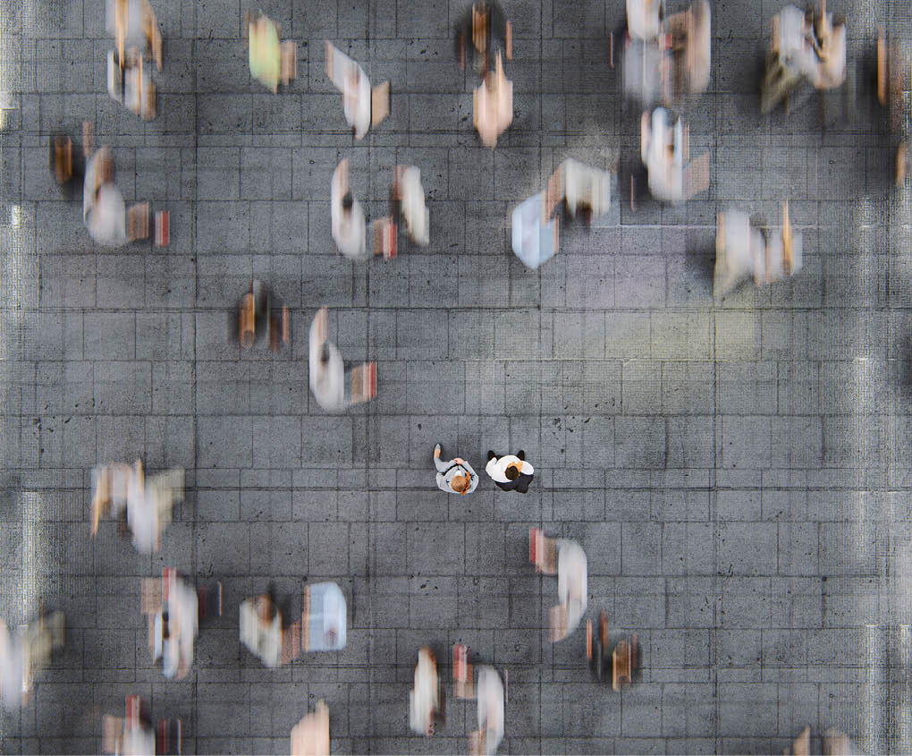 Businessman standing in the fast moving crowds of commuters. This is entirely 3D generated image.